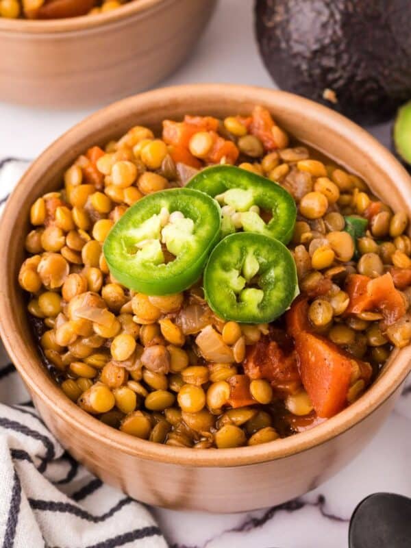 bowl of lentil chili with fresh sliced jalapeño on top.
