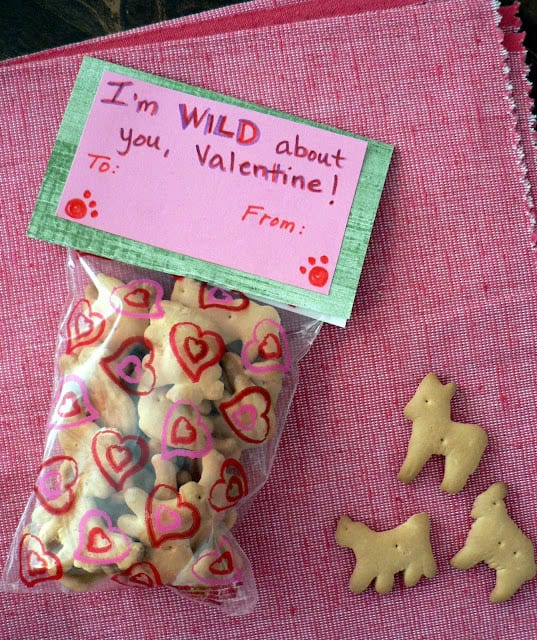 A small clear plastic bag filled with animal crackers and a piece of paper stapled to the top that says I'm WILD about you Valentine.