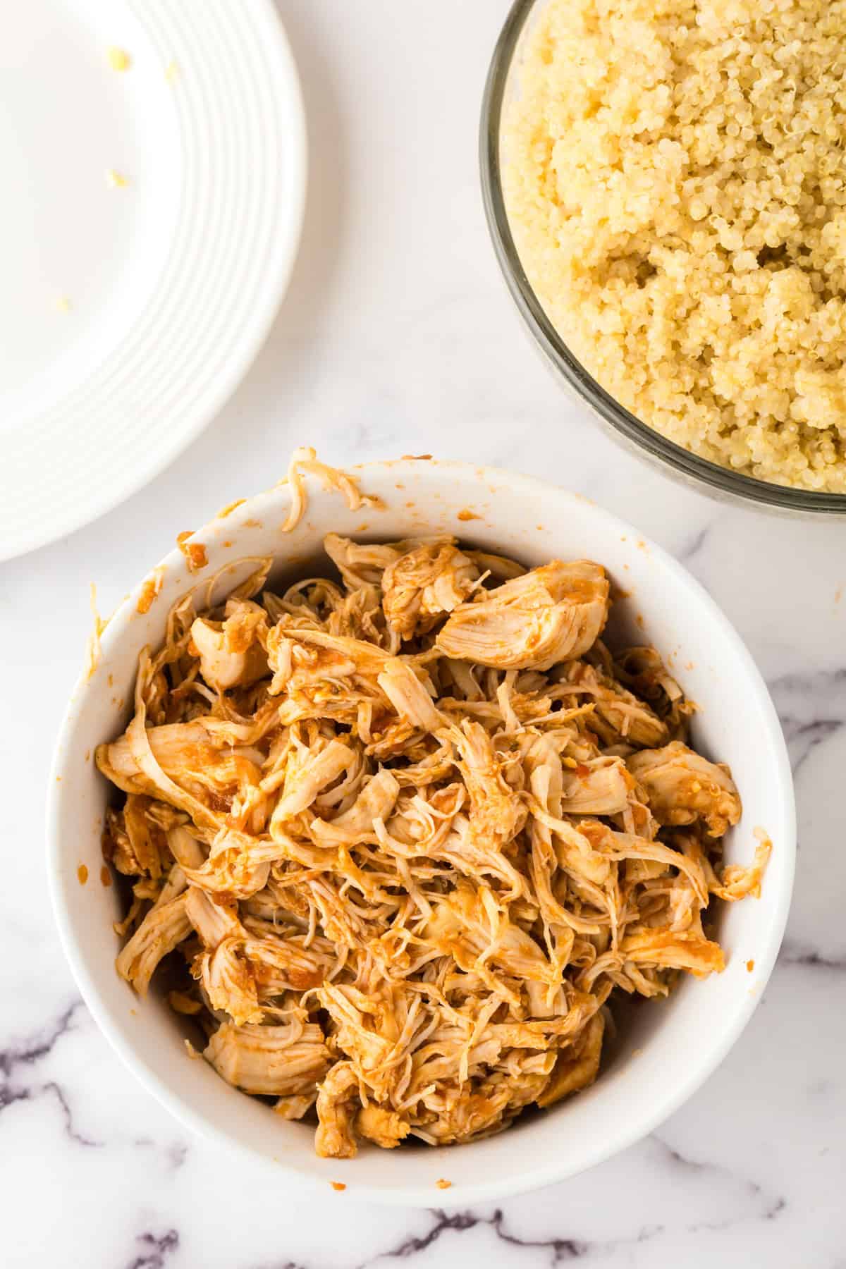 small white bowl with shredded chipotle chicken.