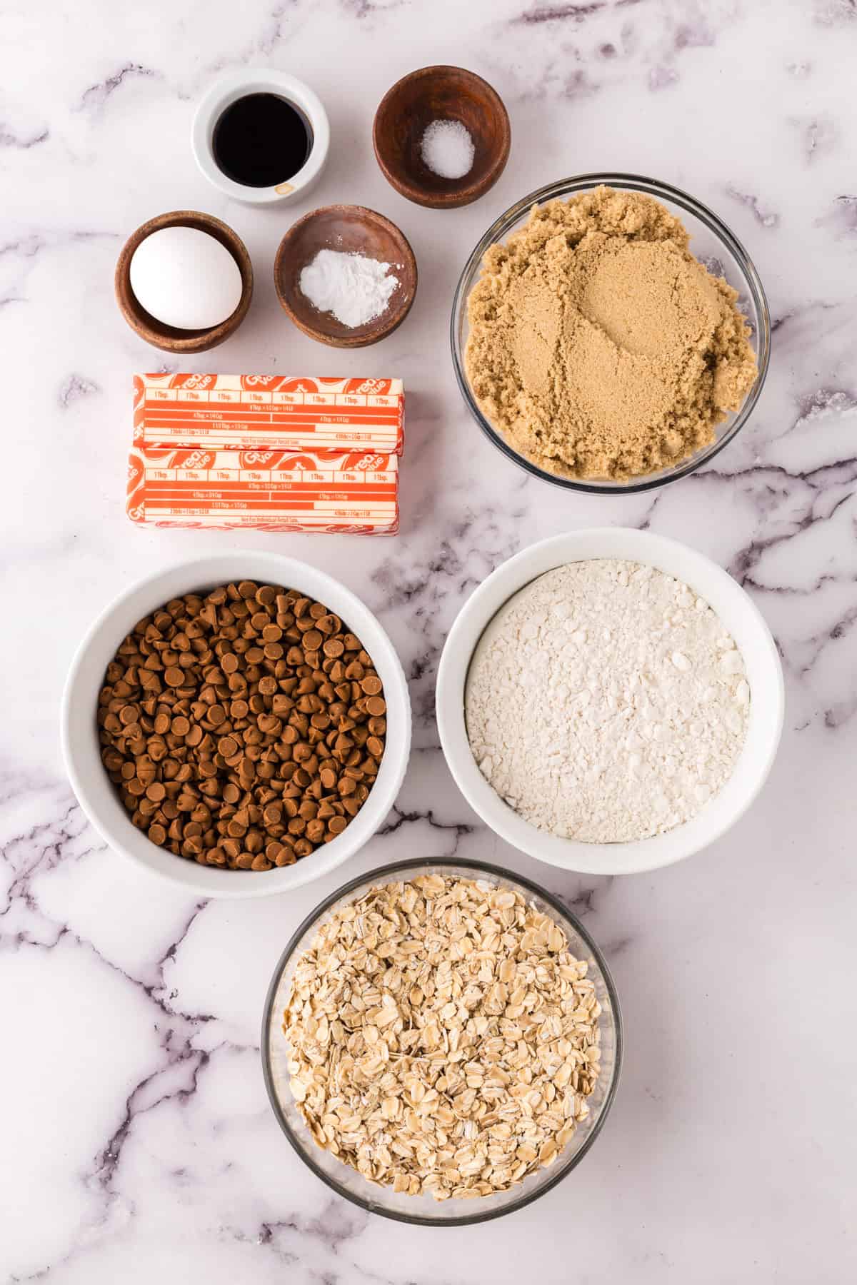 portion bowls each with raw ingredients to make Cinnamon Chip Oatmeal Cookies.