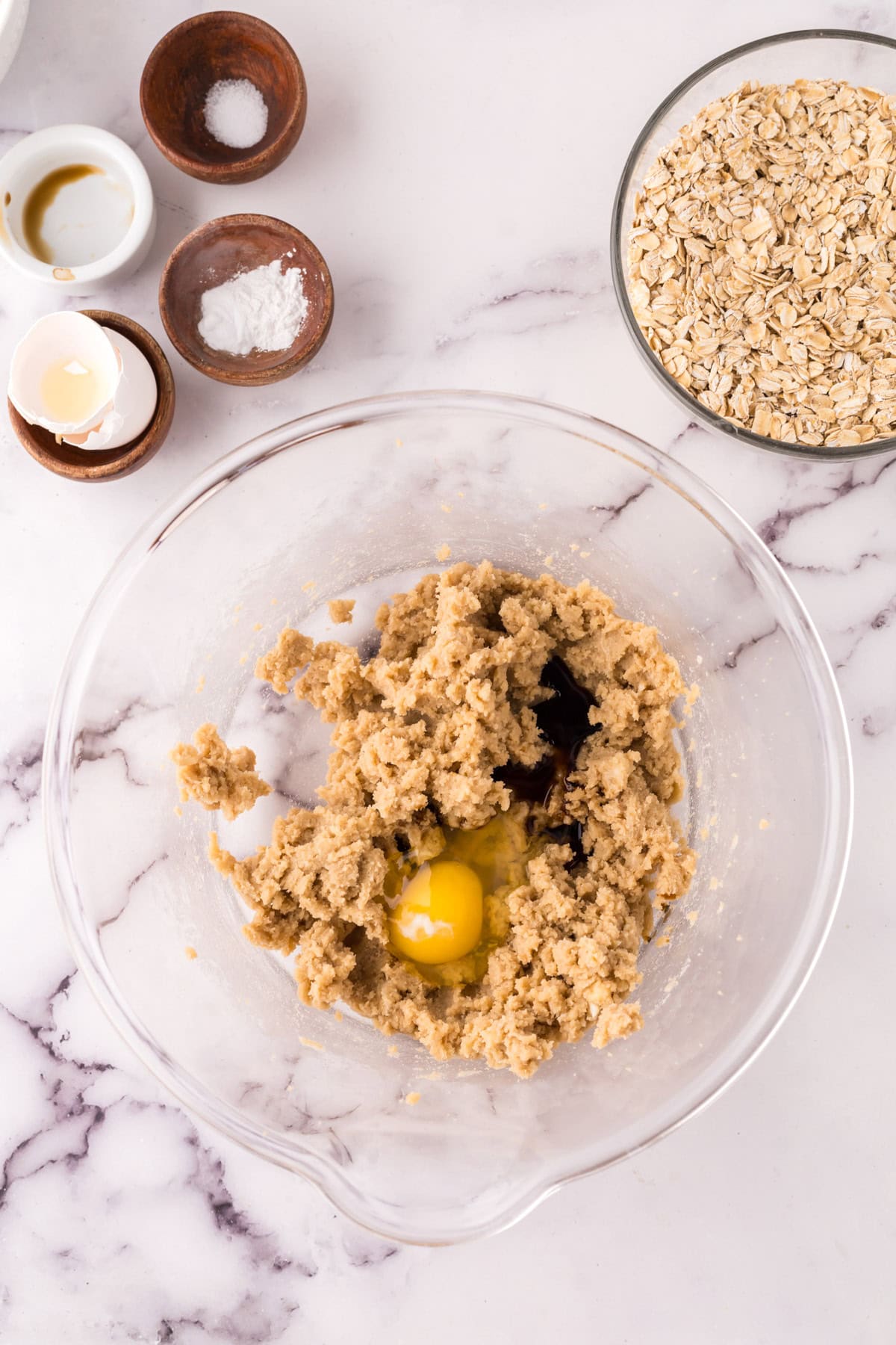 clear mixing bowl the progress of making the cinnamon chip oatmeal cookie recipe.