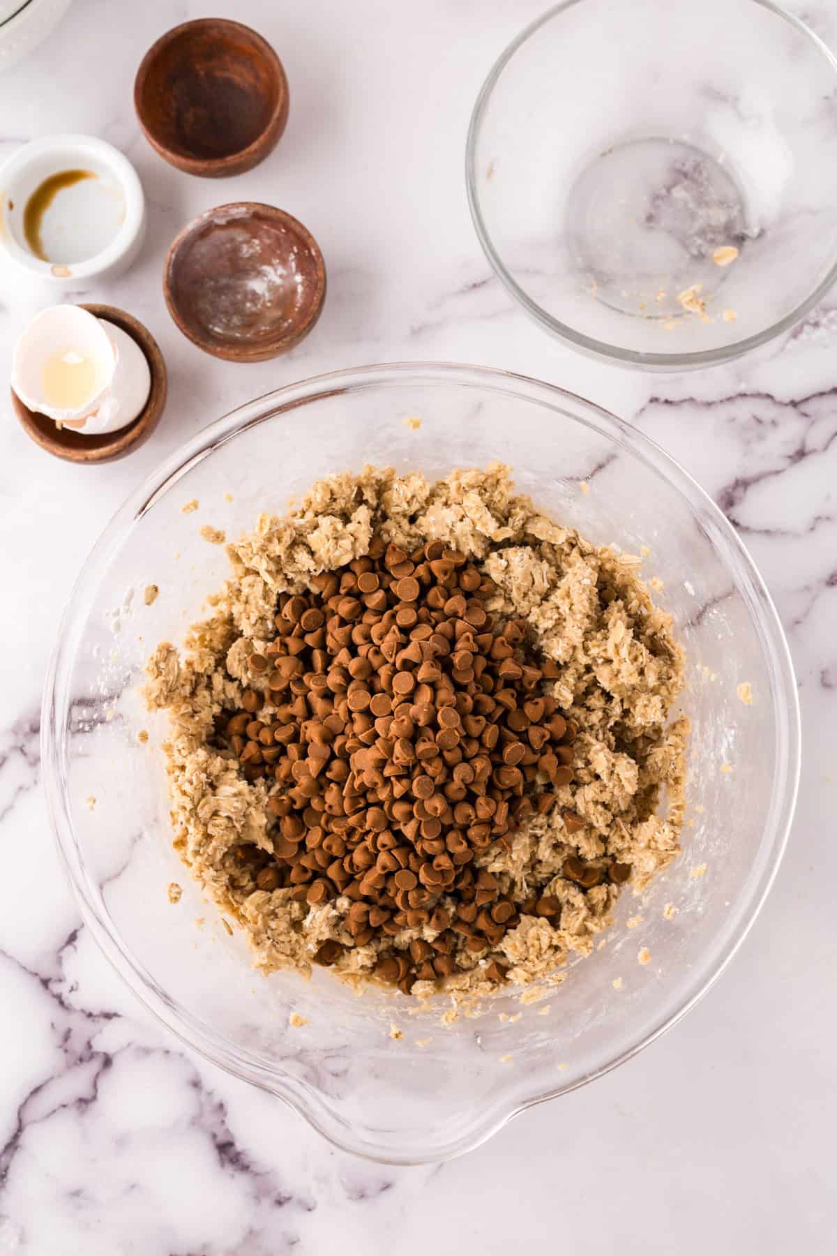 clear mixing bowl the progress of making the cinnamon chip oatmeal cookie recipe.