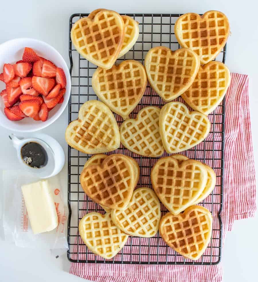 heart shaped homemade waffles on a cooling rack.