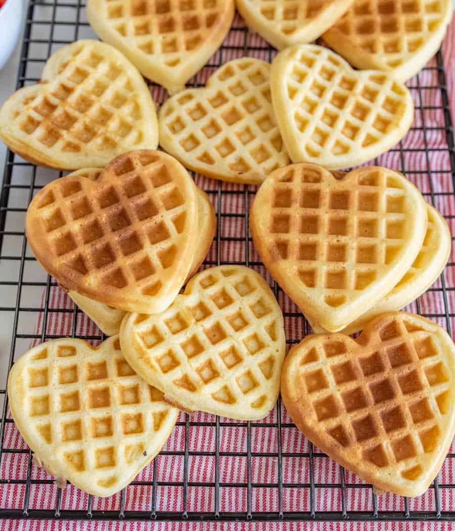 heart shaped homemade waffles on a cooling rack.