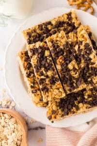 a round plate with rectangle strips of homemade granola bar recipe with chocolate chips on top.