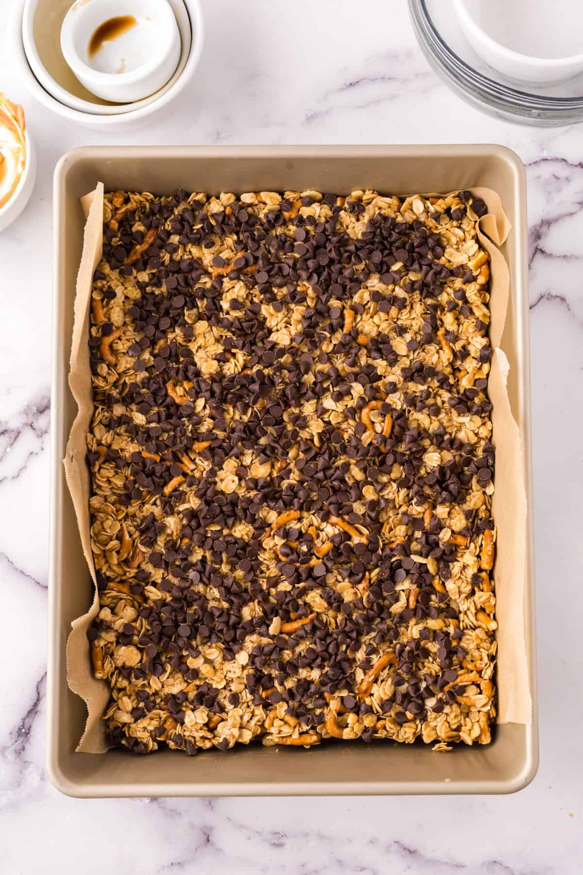 baking dish with the homemade granola bar recipe over parchment paper.