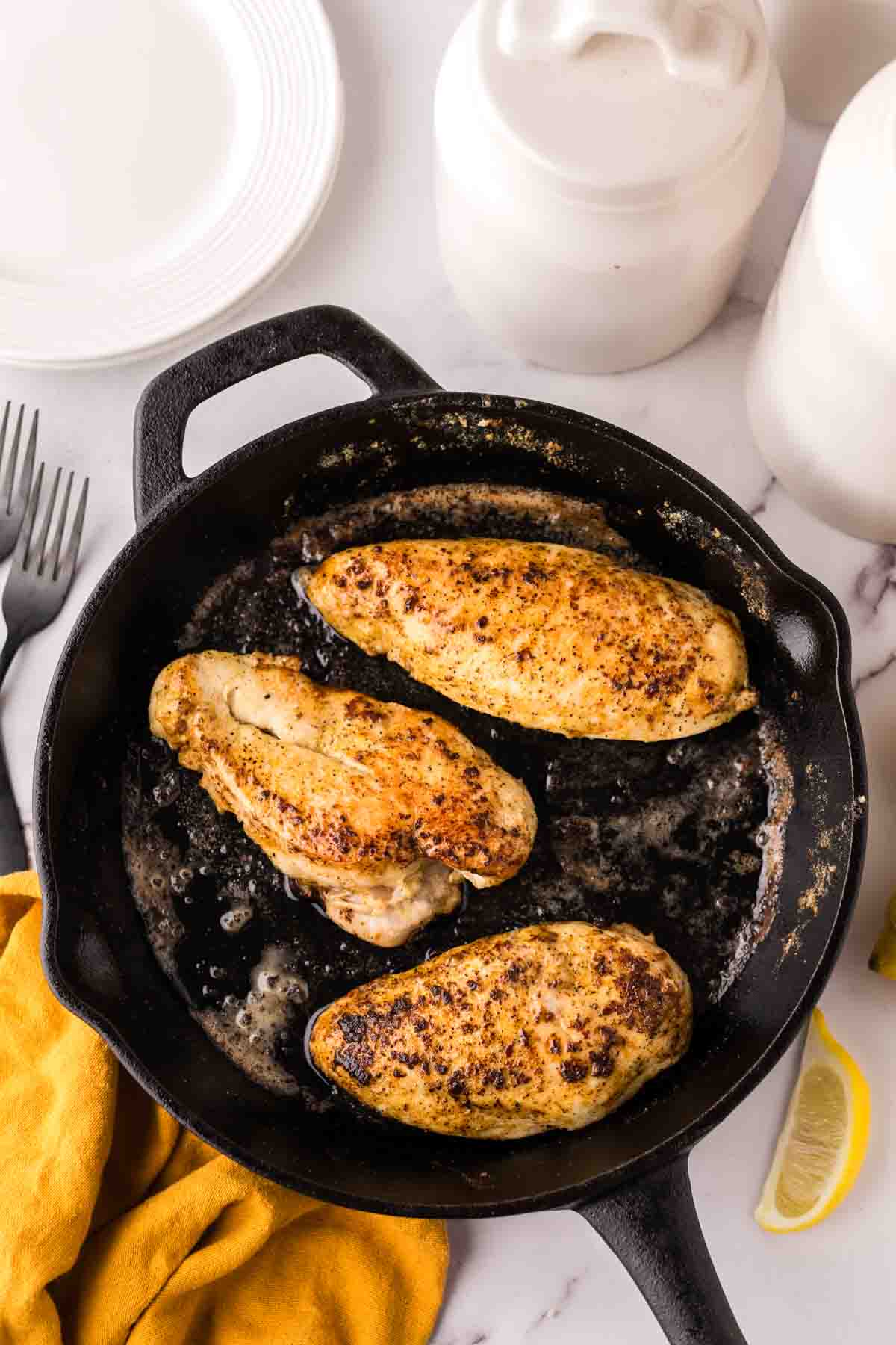 baked chicken breast in a cast iron skillet for the Lemon Pepper Chicken Recipe.