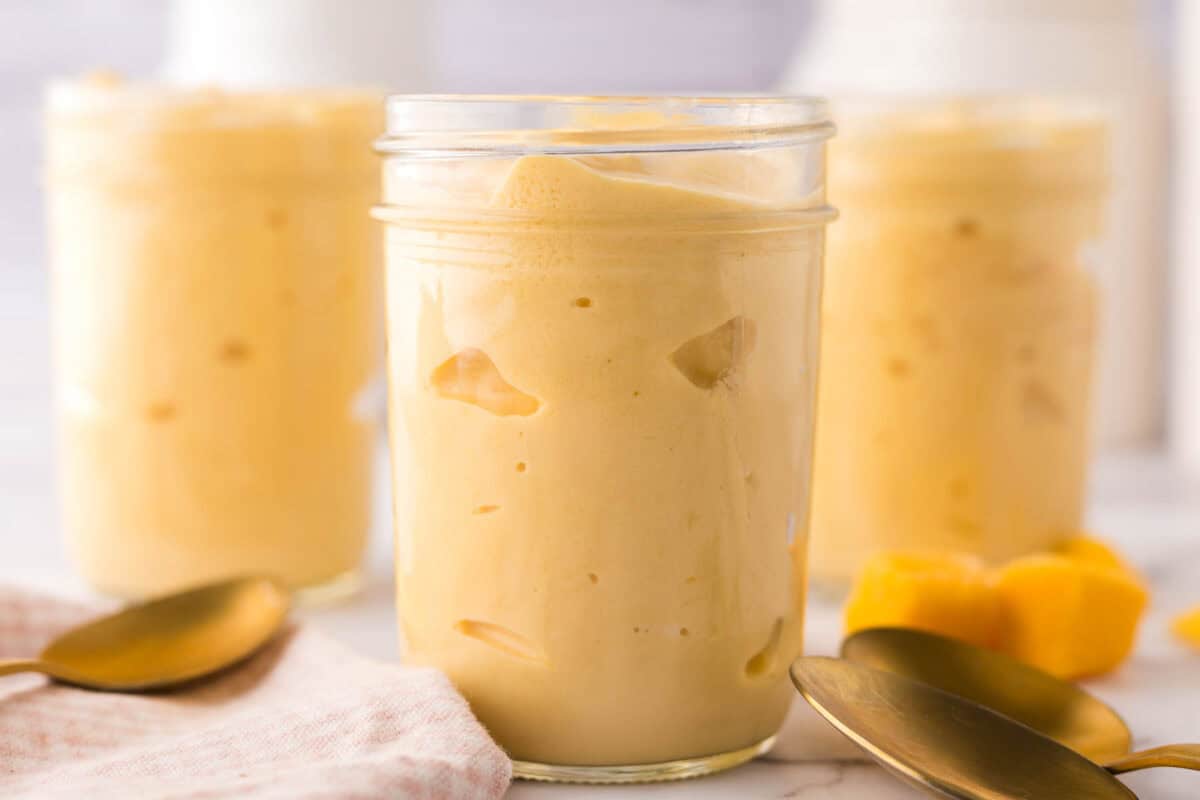 Mango lassi in glass mason jars.