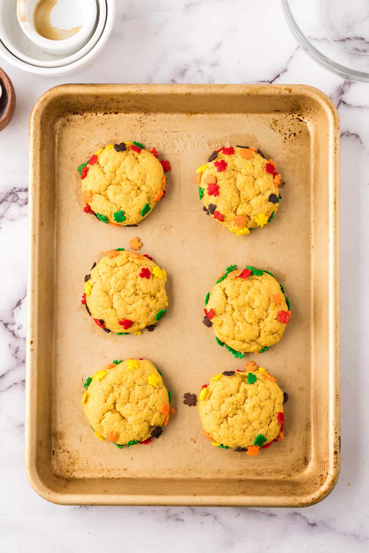 a baking sheet with pumpkin cookies fresh from the oven.