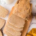 whole loaf with about half sliced and laid out of a fresh baked sandwich bread recipe.