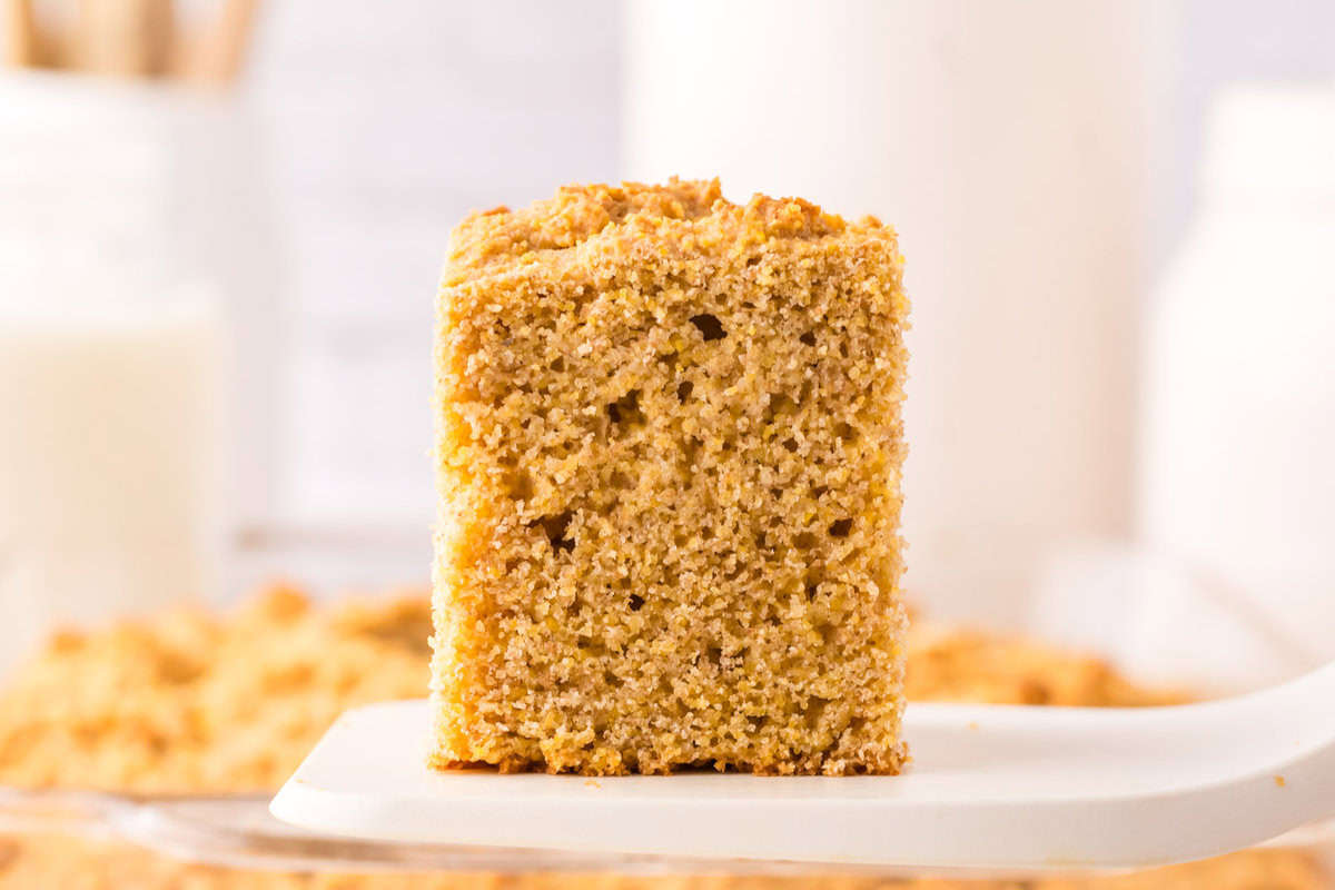 square slice of whole wheat cornbread on a spatula.