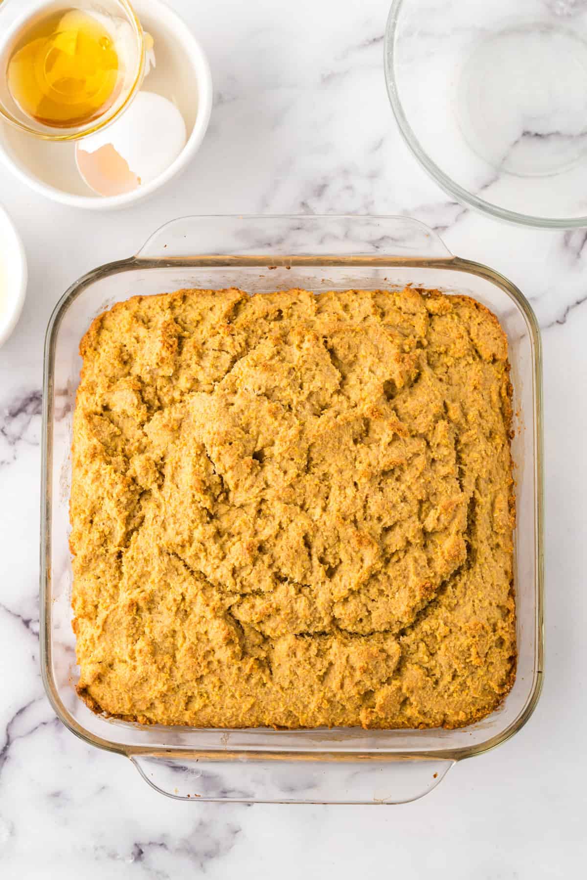 clear baking dish with whole wheat cornbread fresh out of the oven.