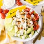 rainbow Grilled chicken salad on a white plate.