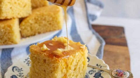 cornbread with butter and honey on a plate