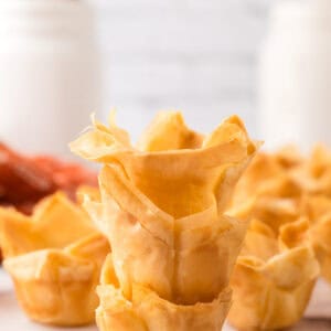 three homemade phyllo cup recipe stacked on the counter.