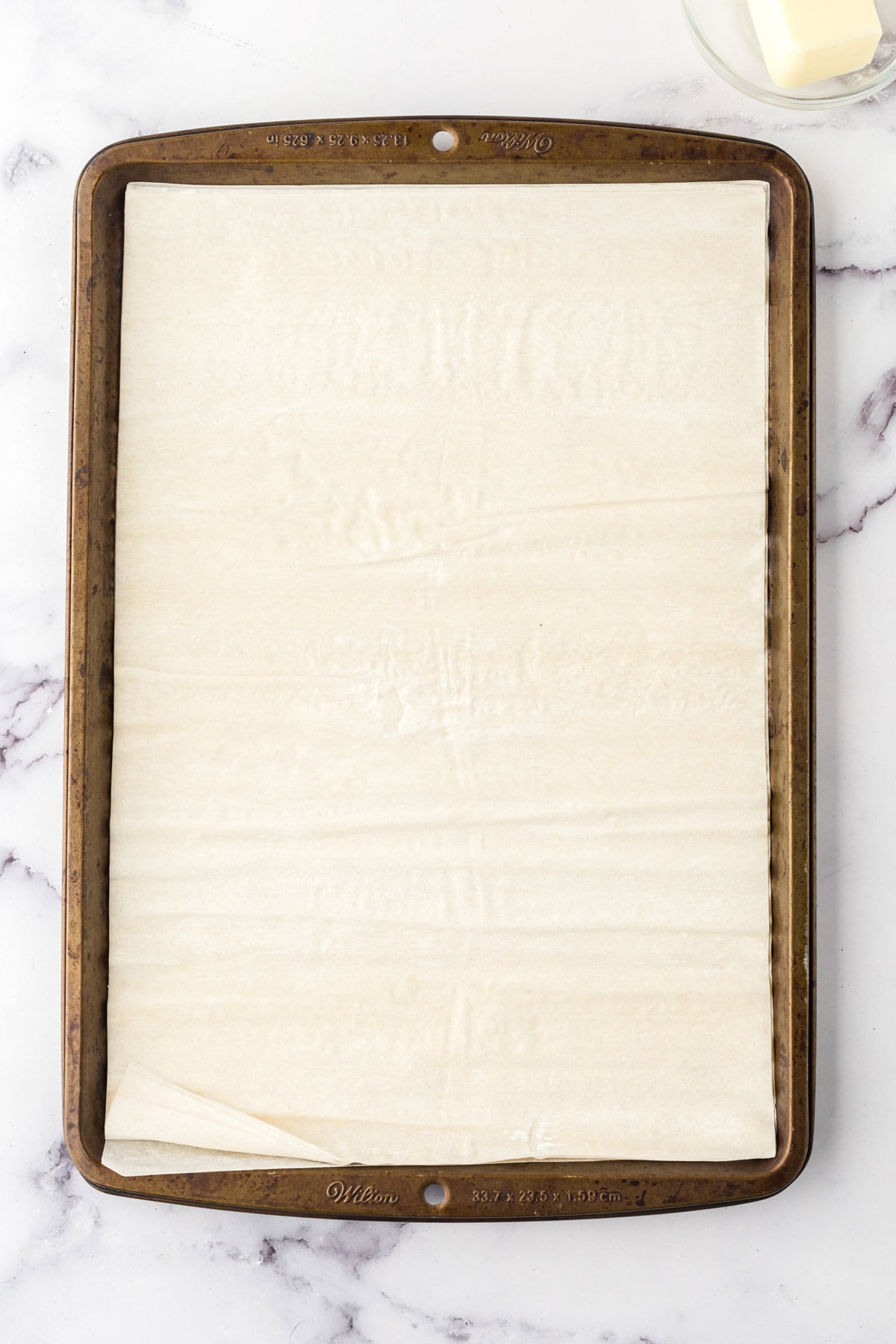 baking sheet with homemade phyllo dough rolled out.