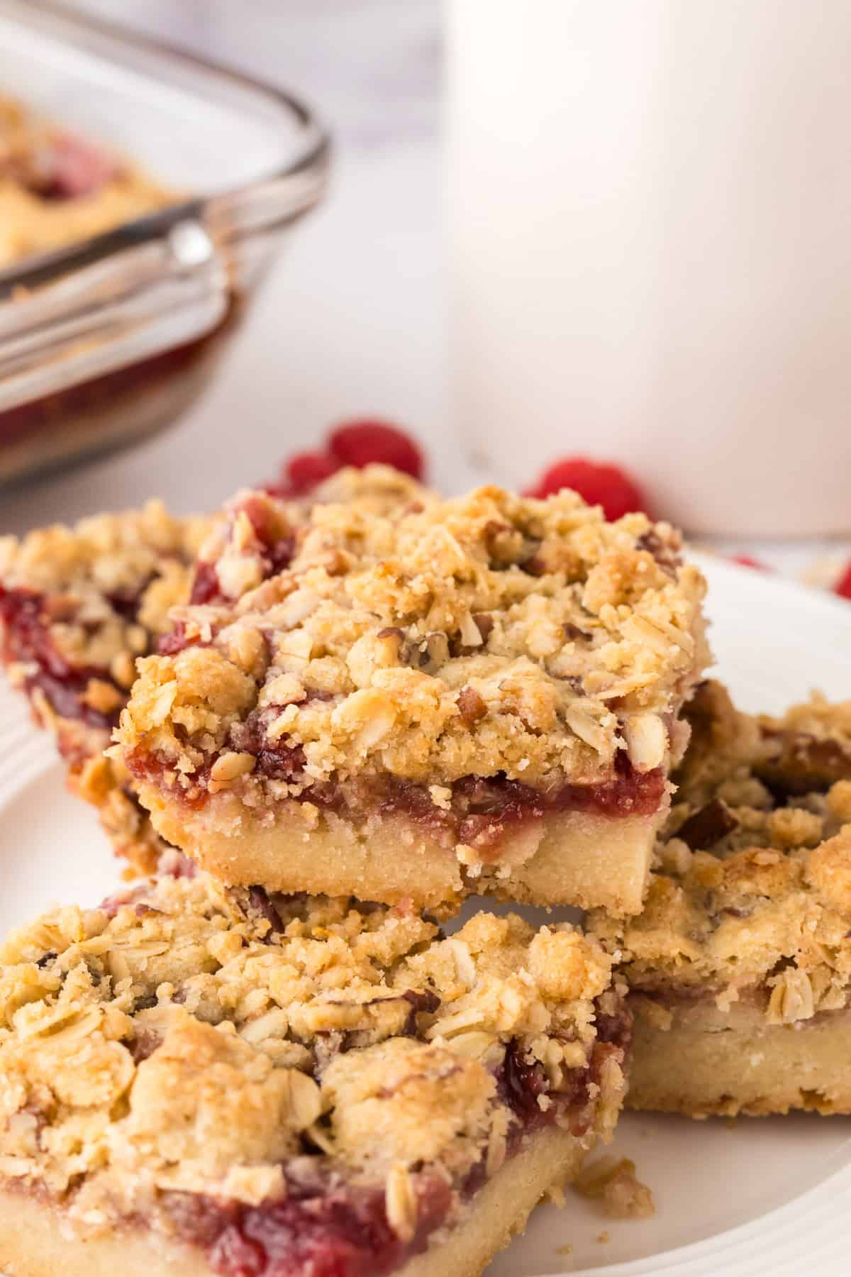 round white plate with squares of raspberry streusel bars.