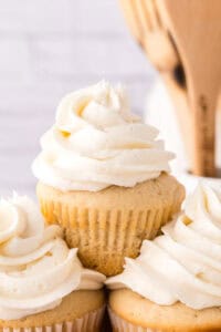 Copycat vanilla cupcakes with vanilla frosting on top in a swirl.