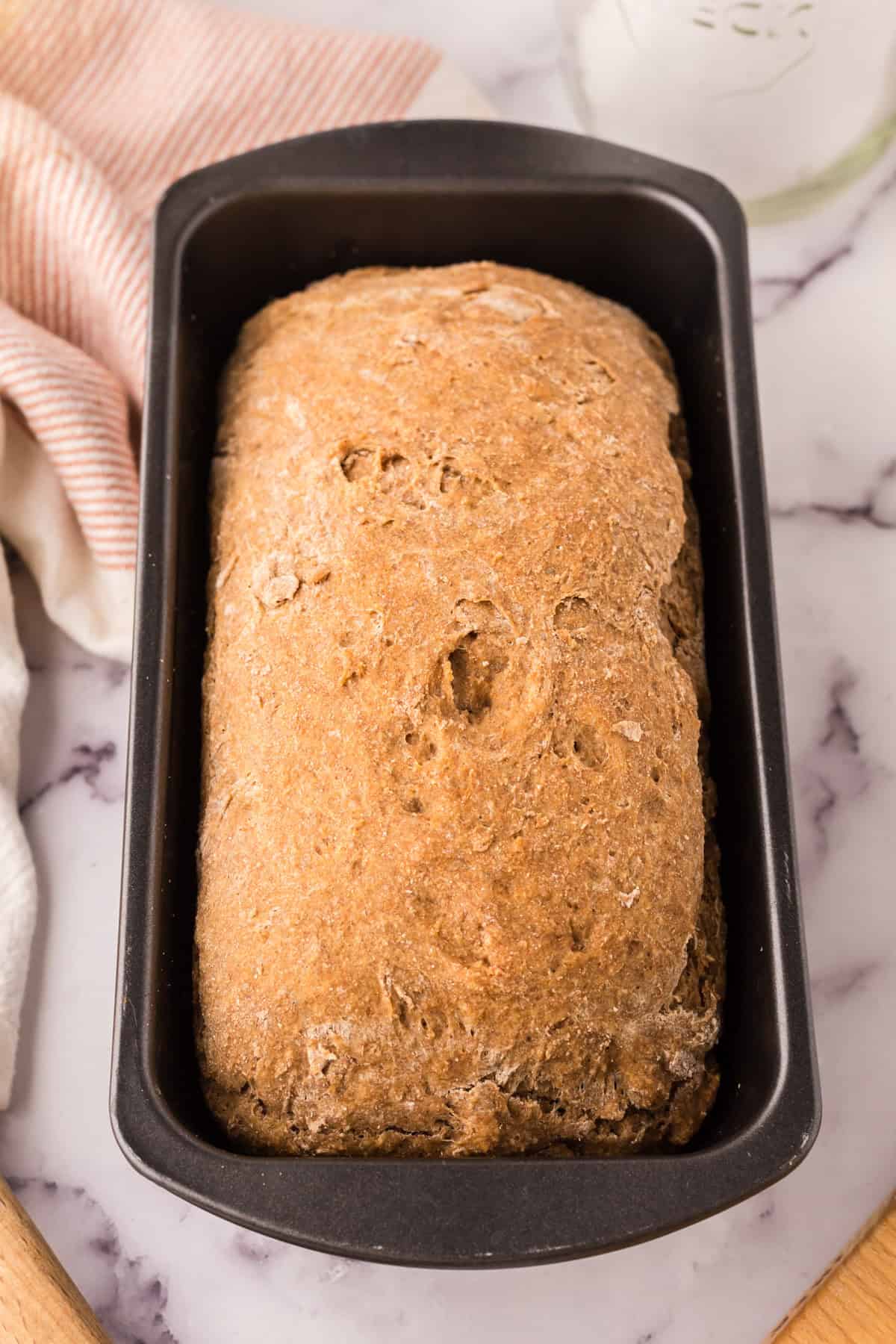 bread tin with wheat bread recipe baked inside.