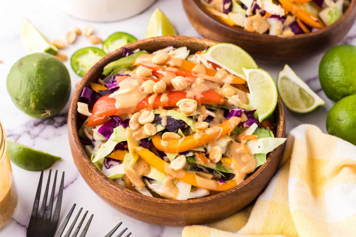 wooden salad bowl with asian chicken salad with peanut dressing.