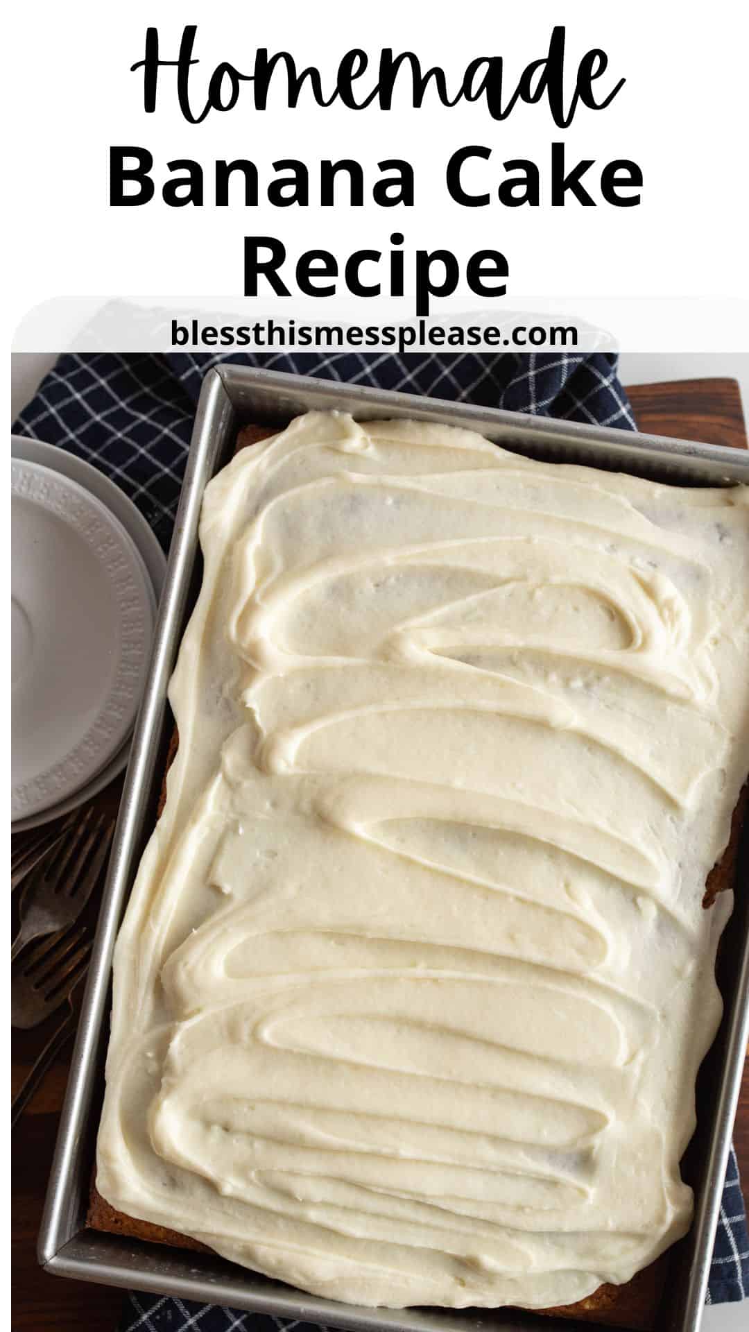 A frosted rectangular banana cake sits in a baking pan on a wooden surface, next to a blue checked towel, two forks, and a white plate. The text above reads Homemade Banana Cake Recipe and blessthismessplease.com.