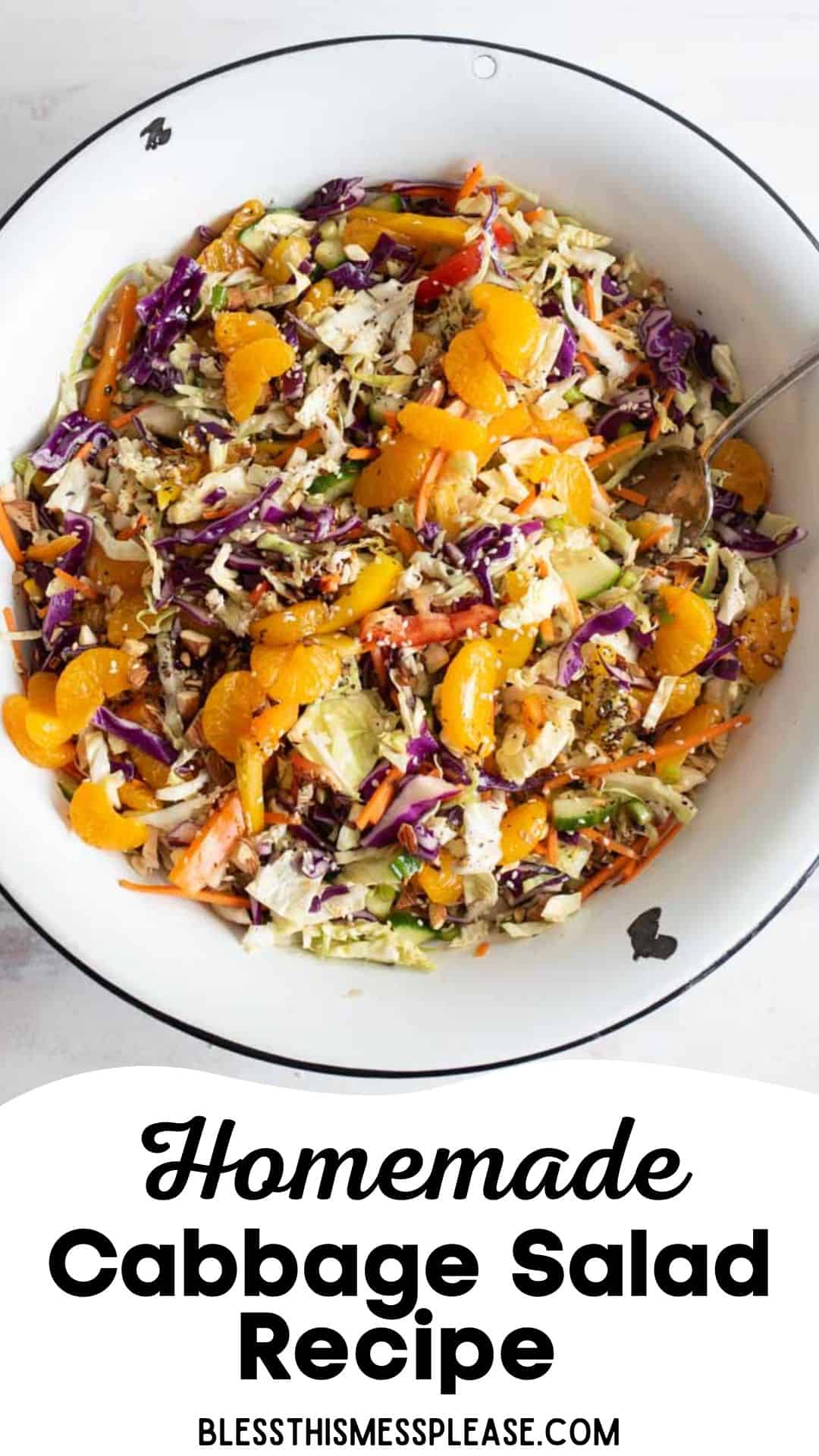 A large white bowl filled with colorful homemade cabbage salad, featuring shredded cabbage, carrots, purple cabbage, and mandarin orange slices, with a serving spoon. Text below reads Homemade Cabbage Salad Recipe.
