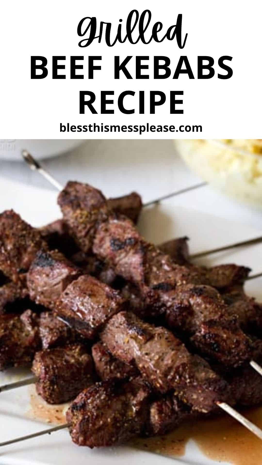 A plate stacked with grilled beef kebabs on metal skewers. The well-seasoned beef kebabs are perfectly cooked, served with a side of potato salad. Text above reads Grilled Beef Kebabs Recipe. Try this easy beef kebabs recipe today!.