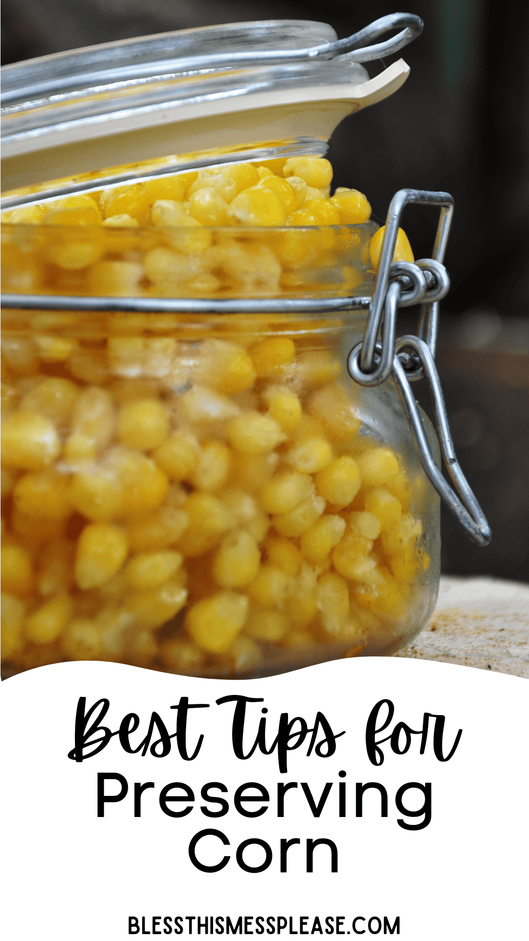A glass jar filled with preserved corn is shown with its lid slightly open. Text below the jar reads “Best Tips for How to Preserve Corn” and “blessthismessplease.com.”.