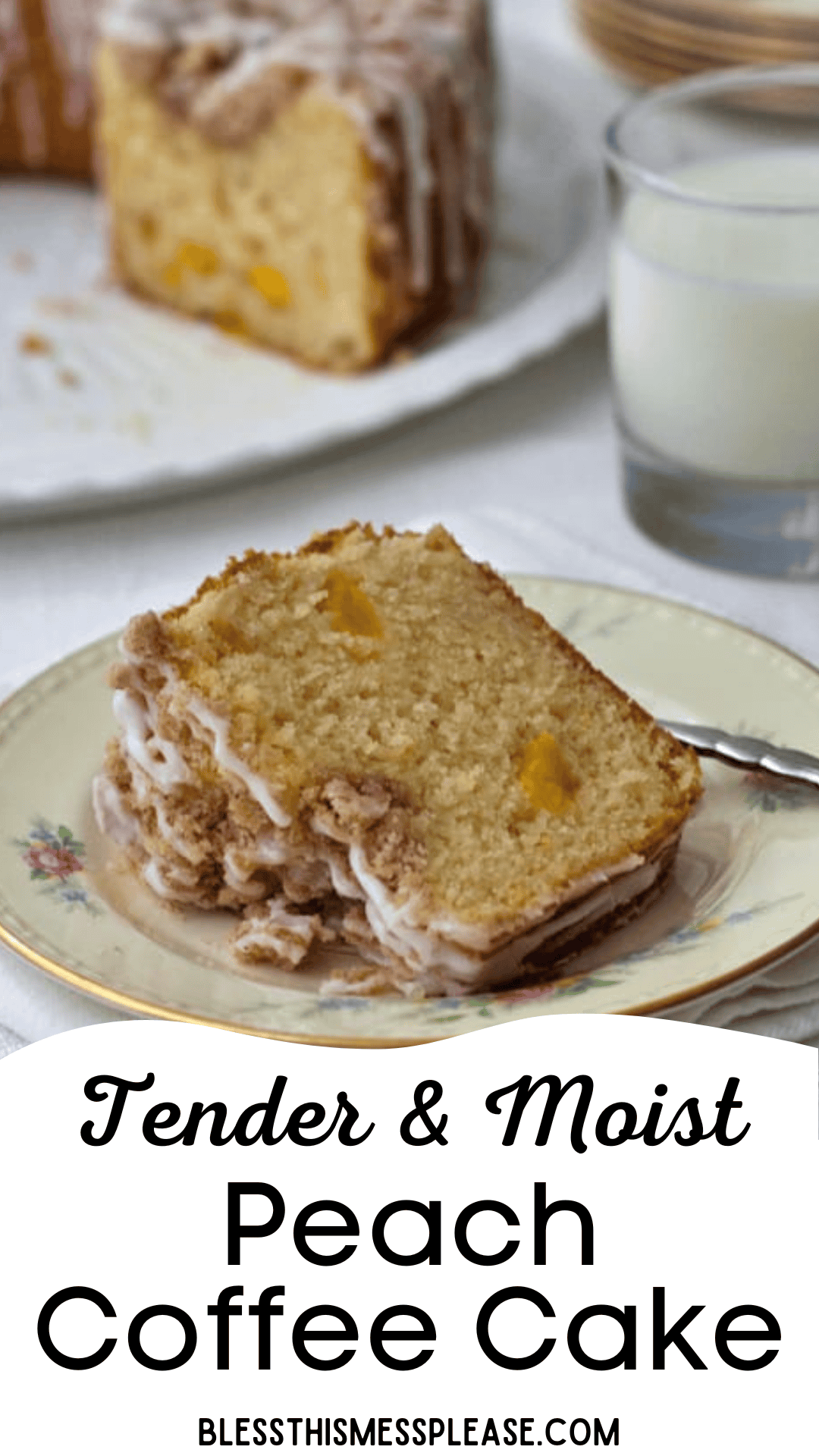 A slice of peach coffee cake with crumb topping and glaze sits on a floral plate with a fork, next to a glass of milk. The rest of the peach coffee cake is in the background. Text reads: Tender & Moist Peach Coffee Cake.