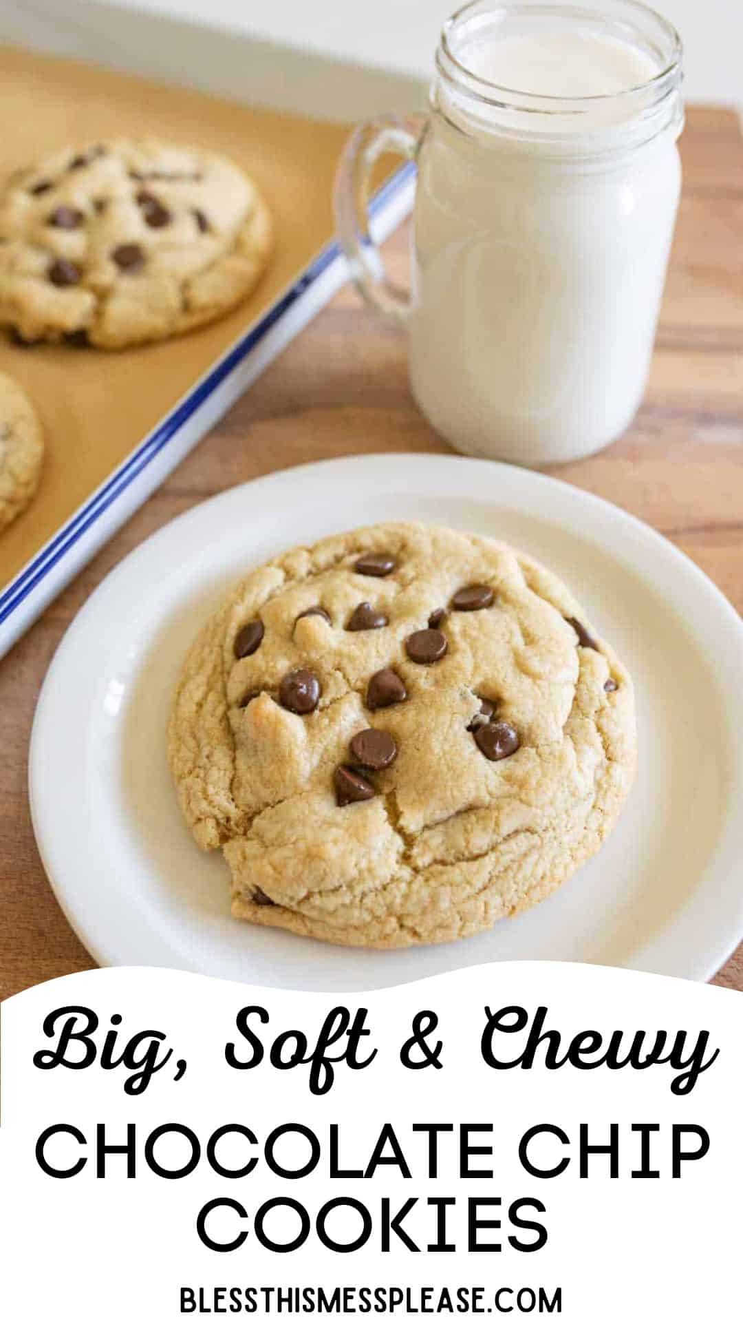 A large, soft chocolate chip cookie sits on a white plate next to a glass jar filled with milk. More cookies are on a baking tray in the background. Text reads: Big, Soft & Chewy—your go-to giant chocolate chip cookie recipe.