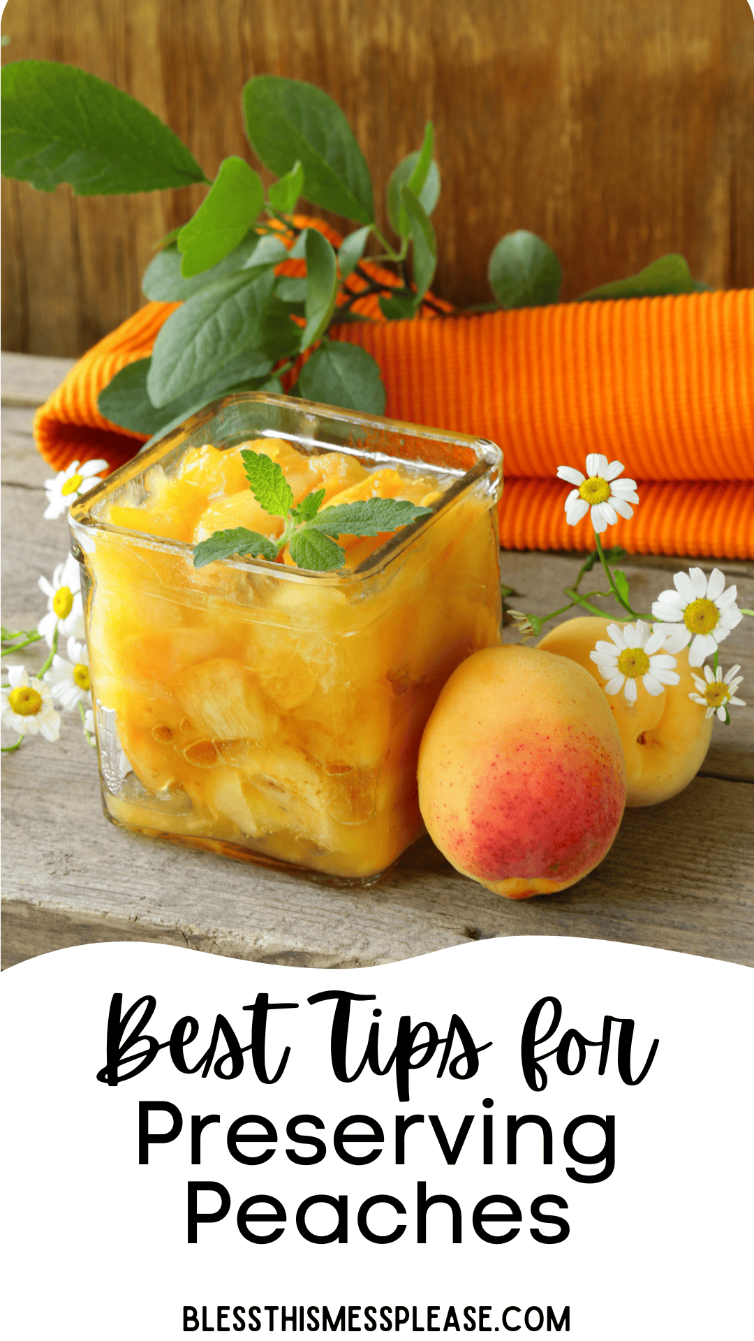 A glass jar filled with preserved peaches sits on a wooden table, surrounded by fresh peaches, white flowers, green leaves, and an orange cloth. Text reads: How to Preserve Peaches—Best Tips. blessthismessplease.com.