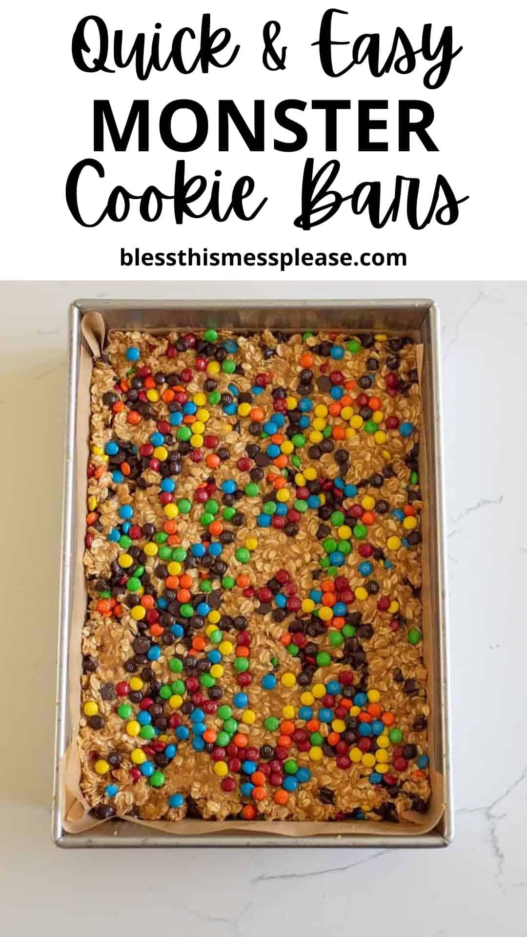 A rectangular pan filled with irresistible monster cookie bars, topped with colorful mini chocolate candies, sits on a white surface. Text above reads, Quick & Easy MONSTER Cookie Bars, blessthismessplease.com.