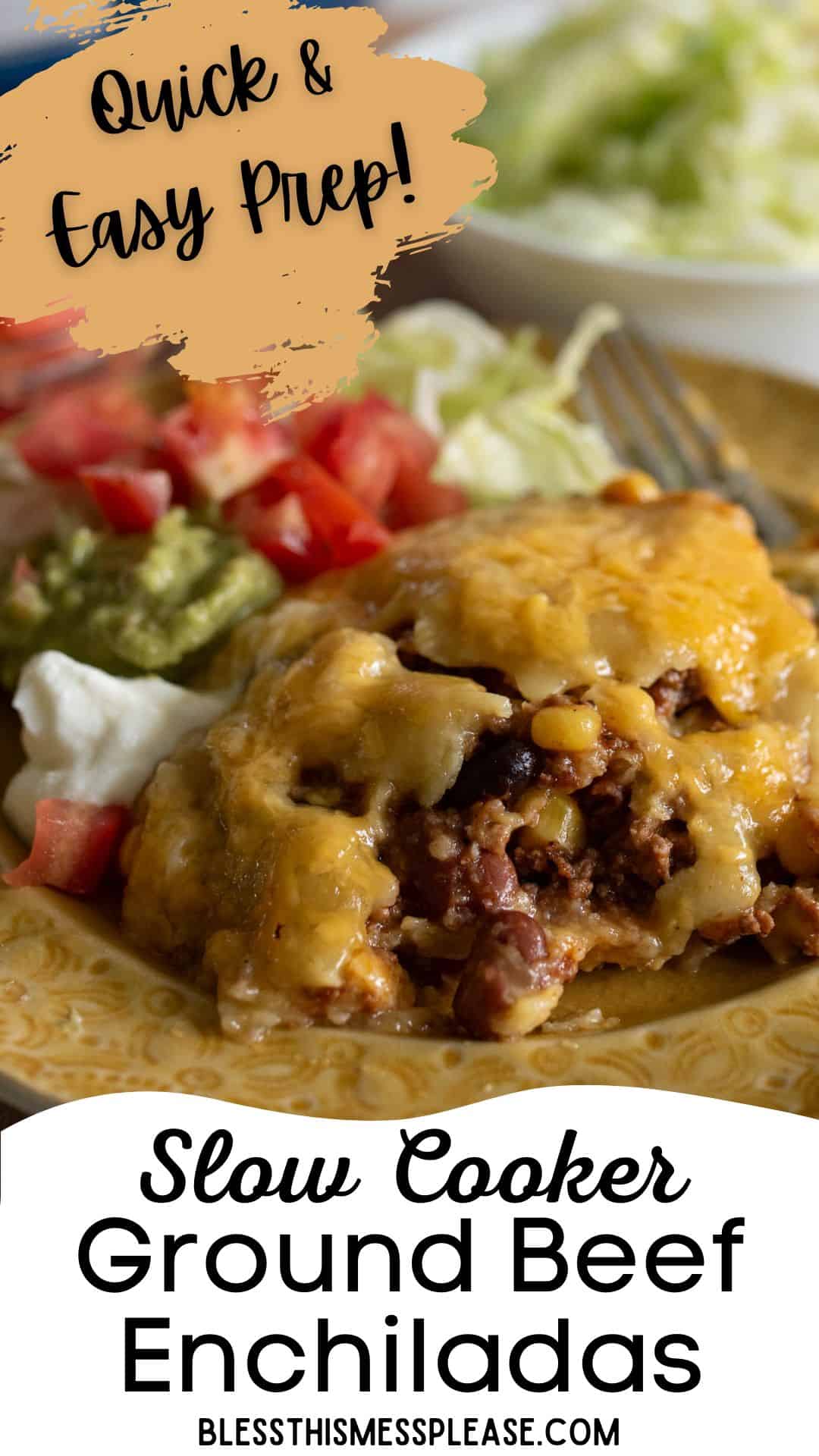 A close-up of cheesy crock pot beef enchiladas on a plate, topped with melted cheese, with guacamole, chopped tomatoes, and lettuce on the side. Text reads: Quick & Easy Prep! Slow Cooker Ground Beef Enchiladas.