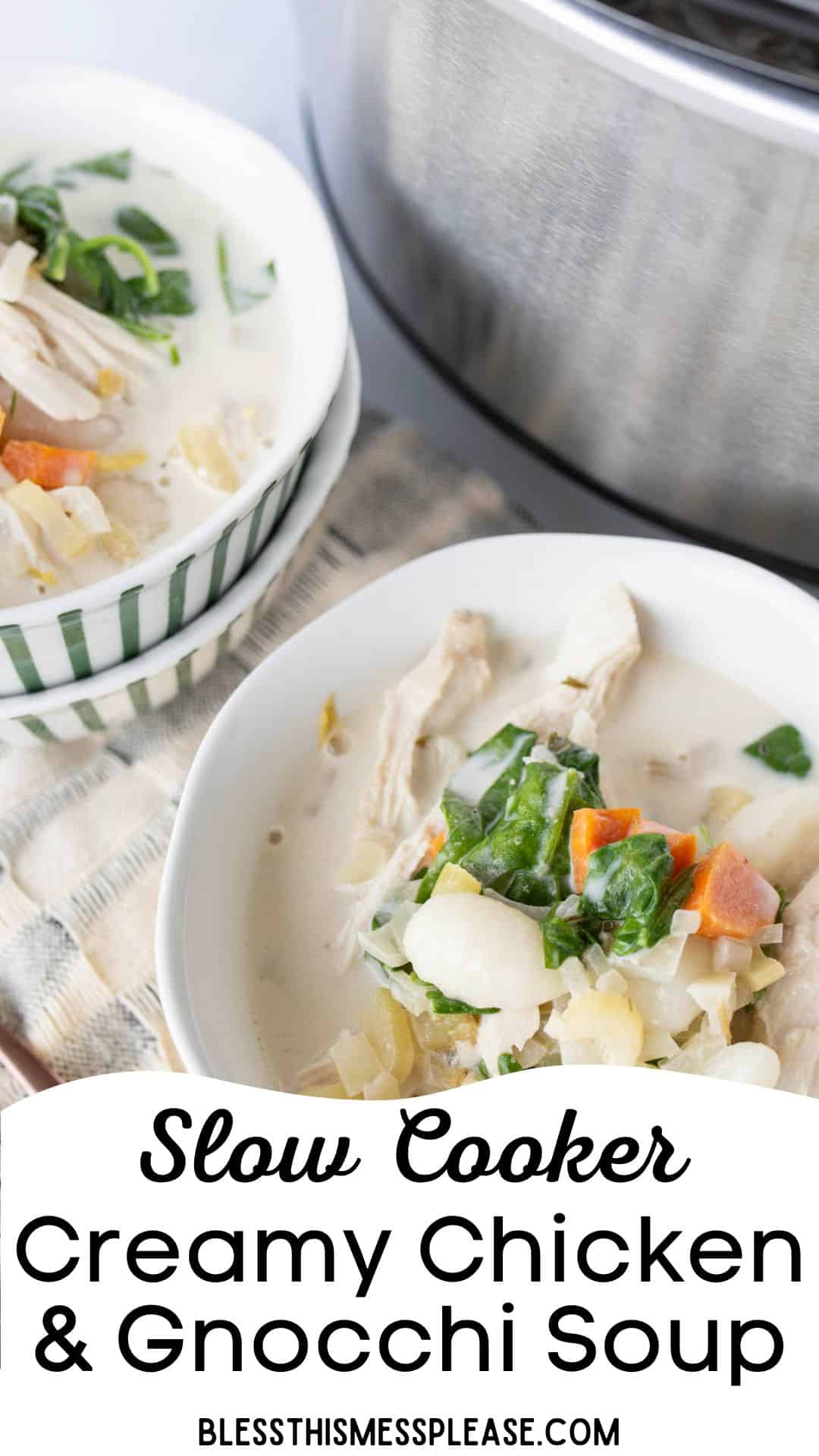 Two white bowls of creamy Italian chicken gnocchi soup with spinach and carrots sit next to a slow cooker. The text at the bottom reads, Slow Cooker Creamy Chicken & Gnocchi Soup.