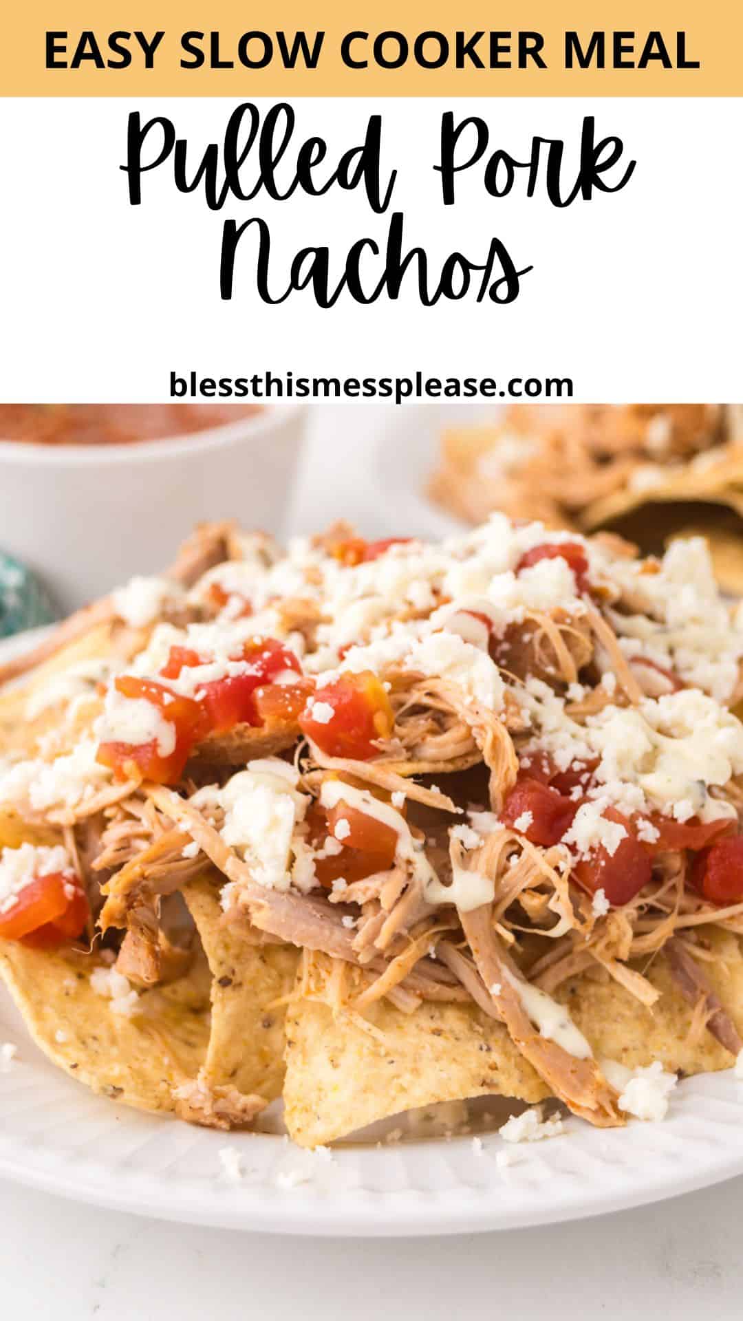 A plate of pulled pork nachos topped with crumbled cheese and diced tomatoes, with a text overlay reading Easy Slow Cooker Meal: Pulled Pork Nachos and the website blessthismessplease.com.