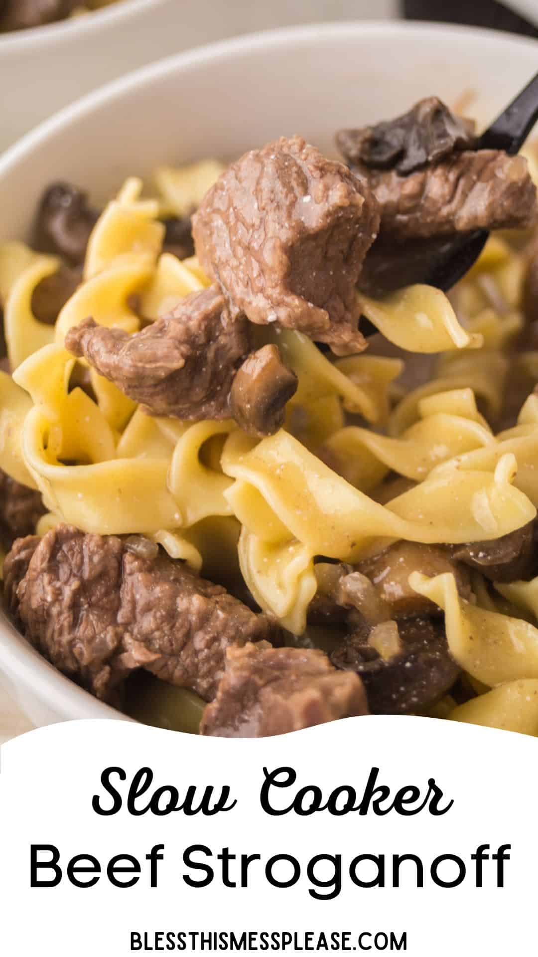 A close-up of a bowl filled with slow cooker beef stroganoff, featuring tender beef strips, wide egg noodles, and mushrooms. A fork lifts a bite. Text at the bottom reads Slow Cooker Beef Stroganoff.