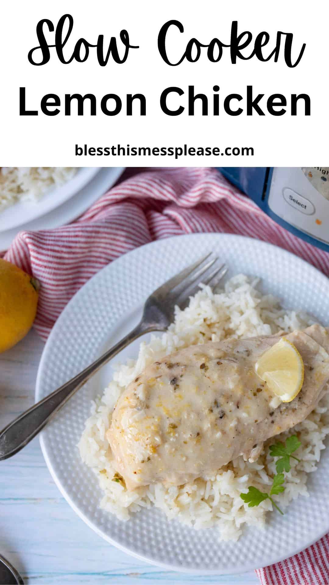 A plate of slow cooker lemon chicken served over white rice, garnished with a lemon wedge and parsley, sits on a white plate with a fork. In the background, a red-striped napkin, fresh lemon, and partial plates enhance the cozy presentation.