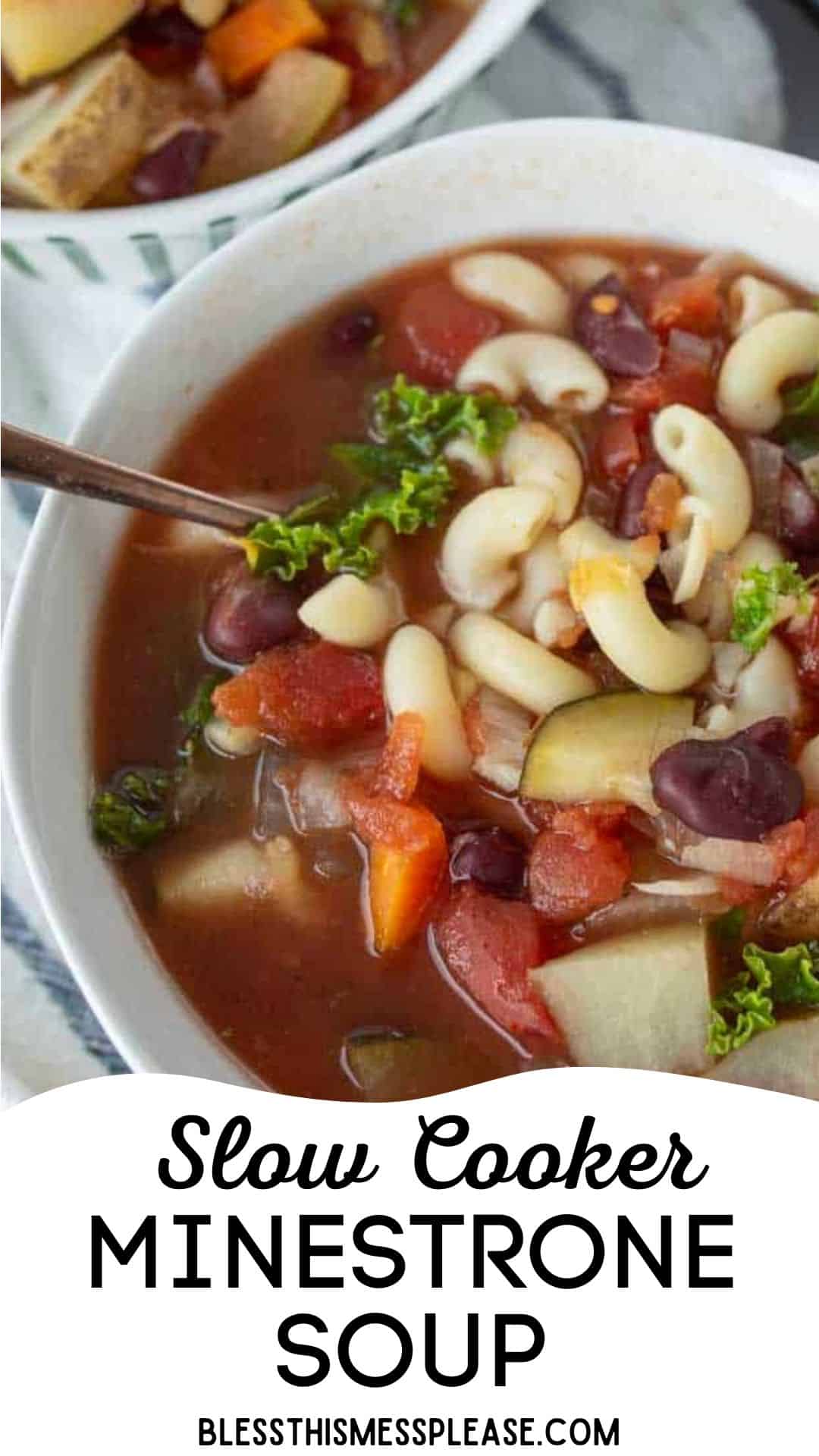 A bowl of slow cooker minestrone soup with macaroni, kidney beans, tomatoes, carrots, potatoes, and kale, with a spoon inside. Text at the bottom reads, Slow Cooker Minestrone Soup, blessthismessplease.com.