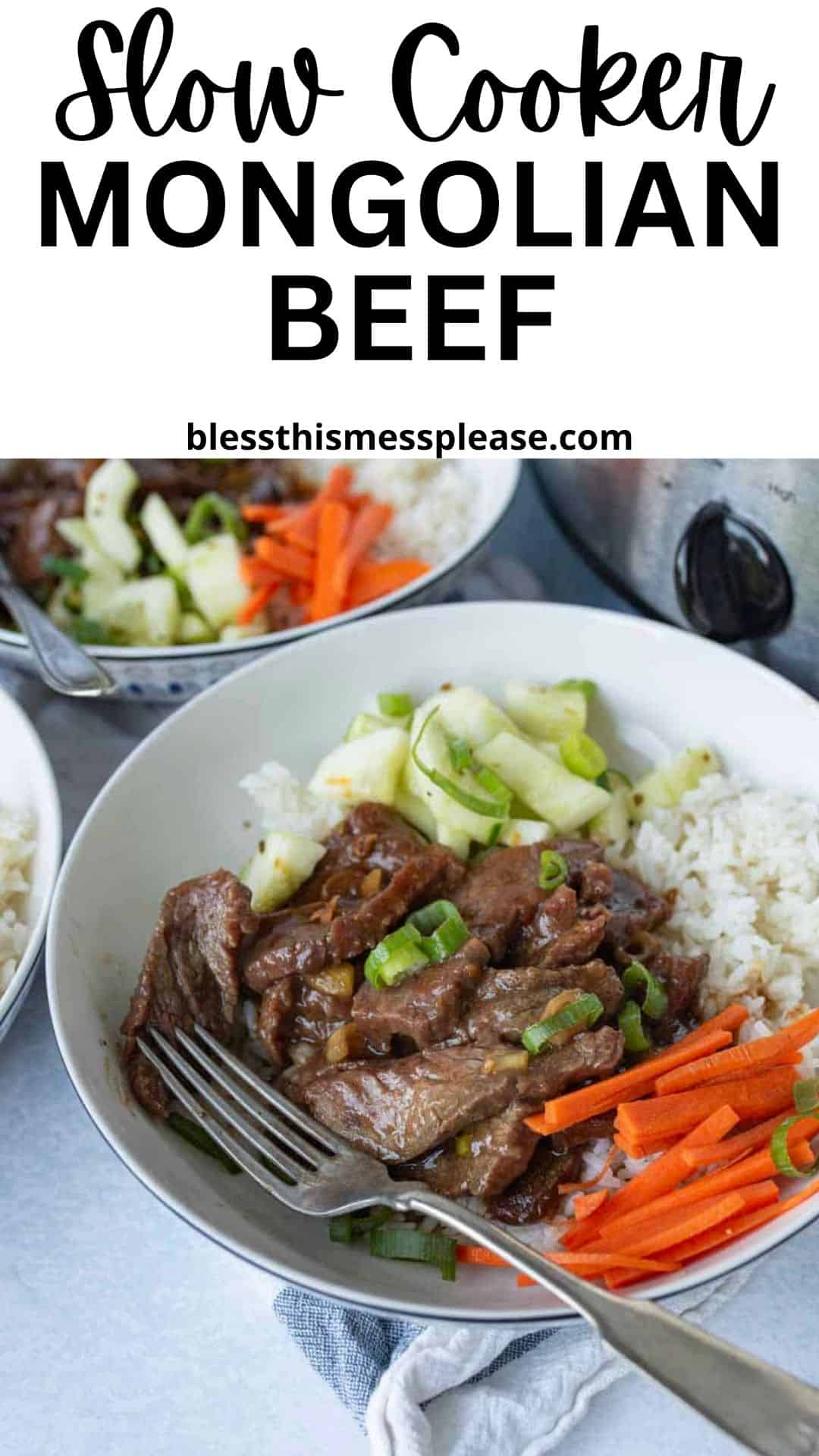 A bowl of slow cooker Mongolian beef served with white rice, sliced carrots, and cucumbers, garnished with green onions. A fork rests in the bowl, and another serving of this savory slow cooker Mongolian beef is nearby.