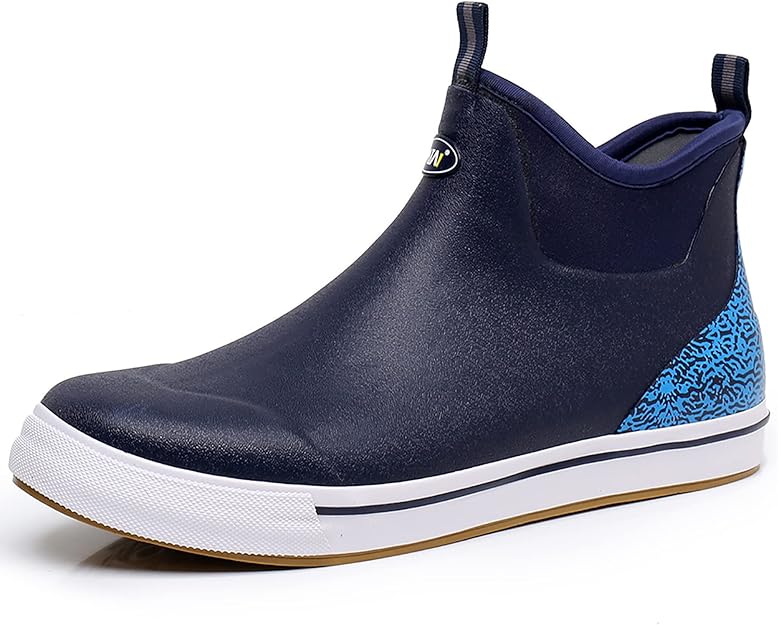 A navy blue slip-on sneaker with a white rubber sole, a textured blue pattern on the heel, and a small pull tab on the ankle. The toe and body are smooth with a subtle sheen.