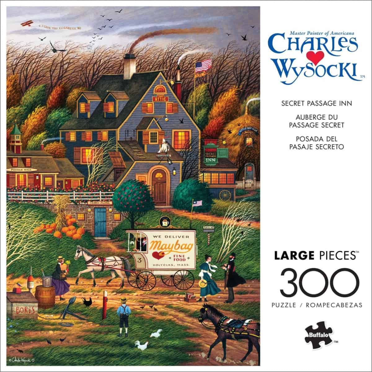 A colorful puzzle box shows a country inn surrounded by autumn trees, people, and animals. A horse-drawn Maybag delivery wagon is in front. The text reads “Charles Wysocki,” “Secret Passage Inn,” and “300 large pieces.”.