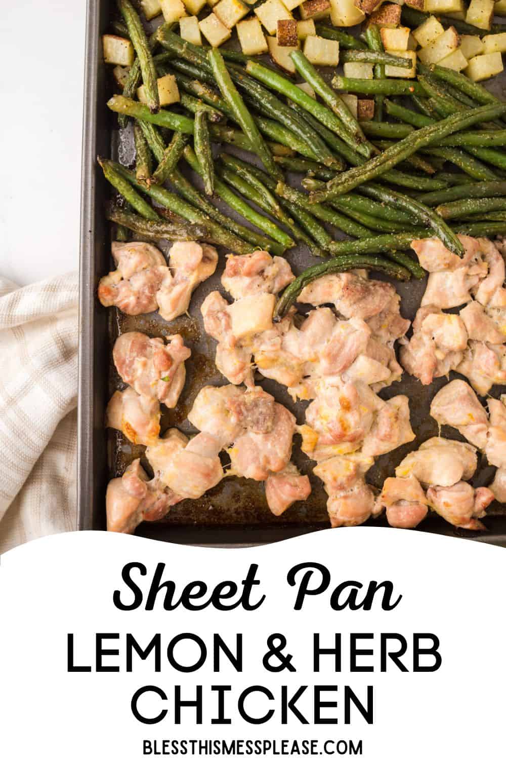 Sheet pan with cooked green beans, cubed potatoes, and rows of lemon and herb chicken, accented by fresh lemon slices. A beige cloth napkin is beside the pan. Text on image reads: Sheet Pan Lemon & Herb Chicken.