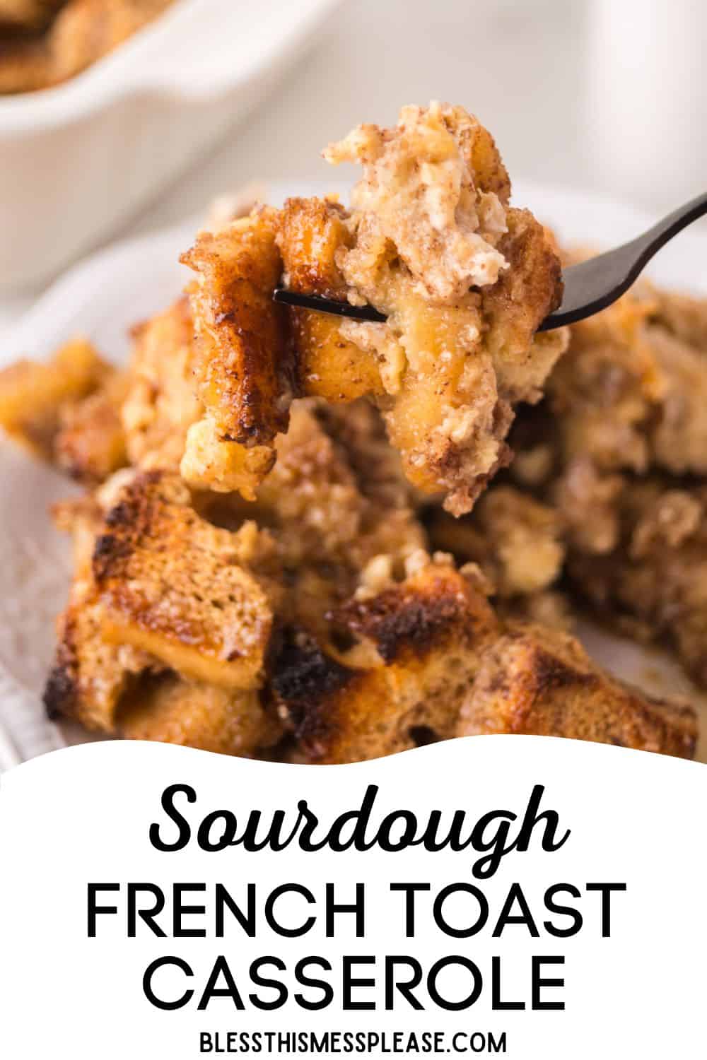 A fork lifts a bite of golden-brown sourdough French toast casserole above a plate piled with more of the baked, cinnamon-spiced dish. Text below reads, Sourdough French Toast Casserole.