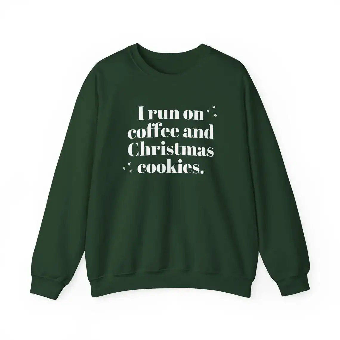 A dark green sweatshirt with white text that reads, I run on coffee and Christmas cookies, surrounded by small star-like decorations.