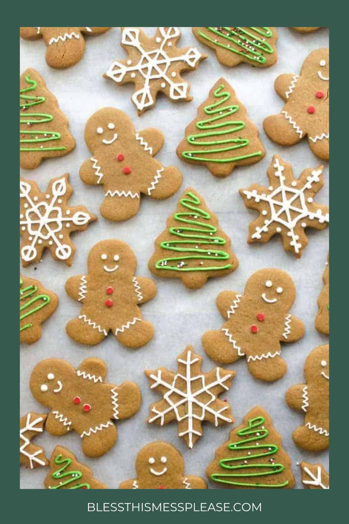 Christmas cookies shaped like gingerbread people, Christmas trees with green icing, and snowflakes with white icing, arranged on parchment paper. Website text BLESSTHISMESSPLEASE.COM at the bottom.