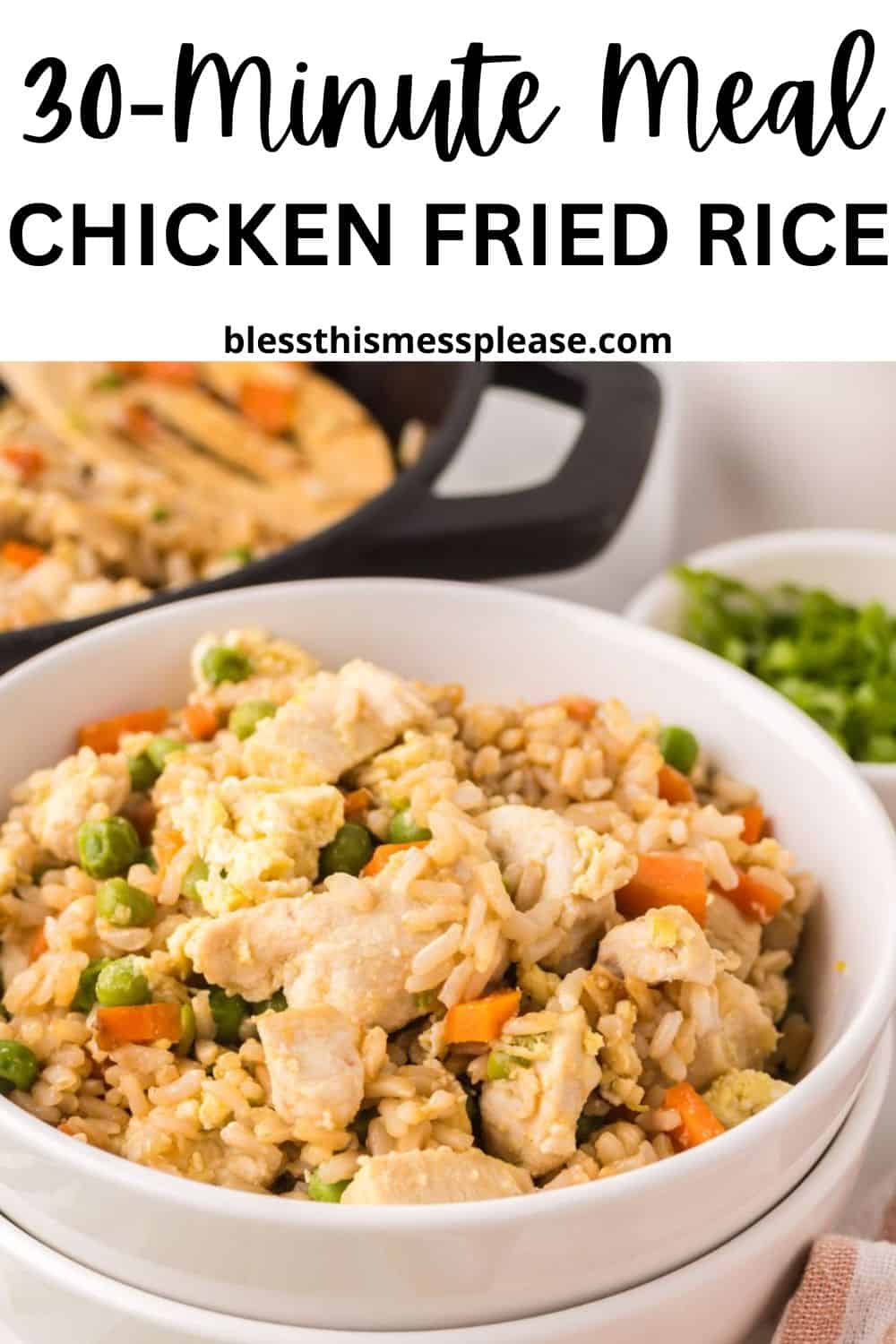 A white bowl filled with chicken fried rice containing peas, carrots, and chunks of chicken. In the background, a skillet shows the process of making chicken fried rice, with a small bowl of green peas. Text reads: 30-Minute Meal Chicken Fried Rice.