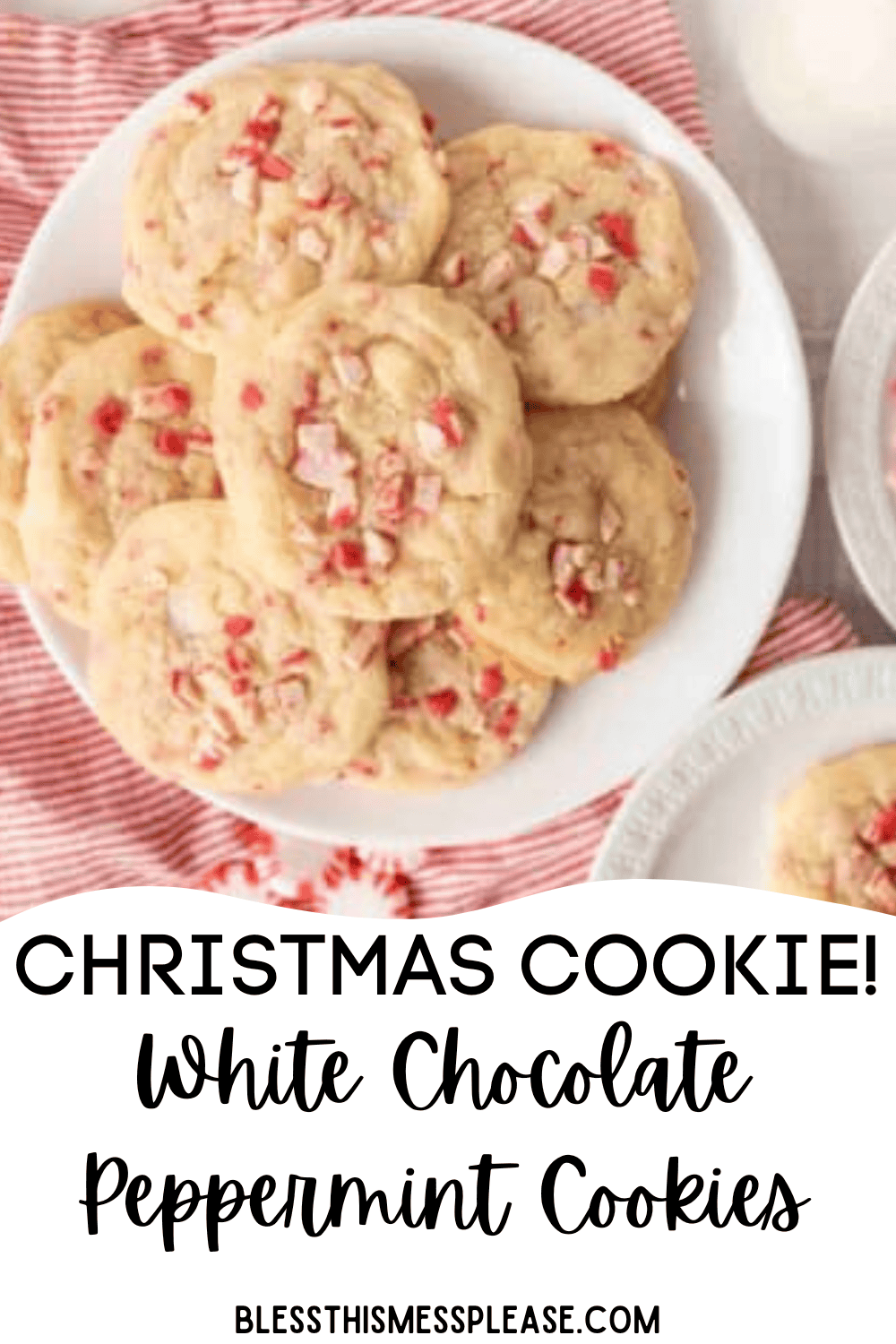 A plate of freshly baked white chocolate peppermint cookies rests on a red and white striped cloth, with extra cookies nearby on a white plate. Text below reads: CHRISTMAS COOKIE! Indulge in festive white chocolate peppermint cookies.