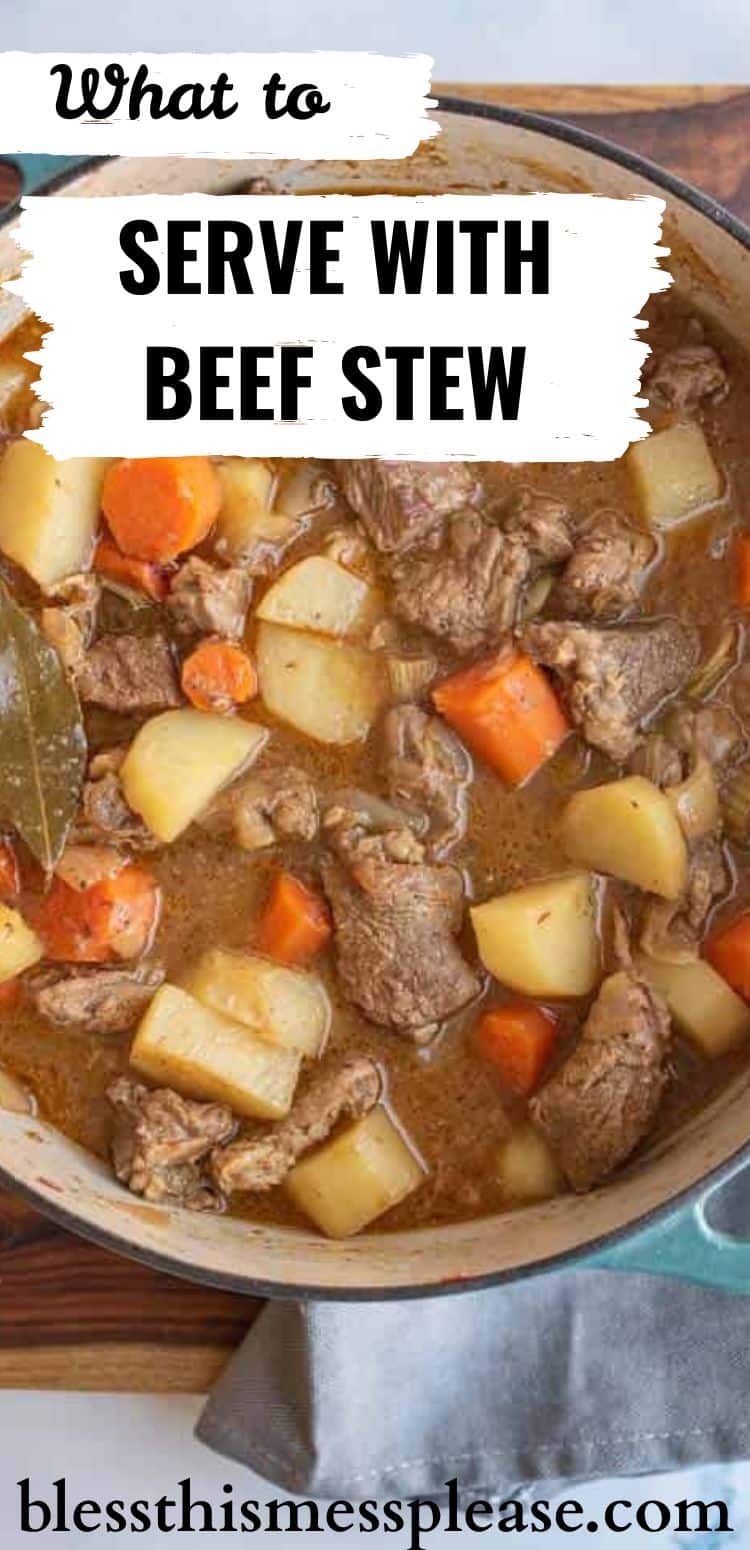 A pot of beef stew with tender beef, potatoes, carrots, and a bay leaf in savory broth. Text on the image asks what to serve with beef stew and includes blessthismessplease.com.